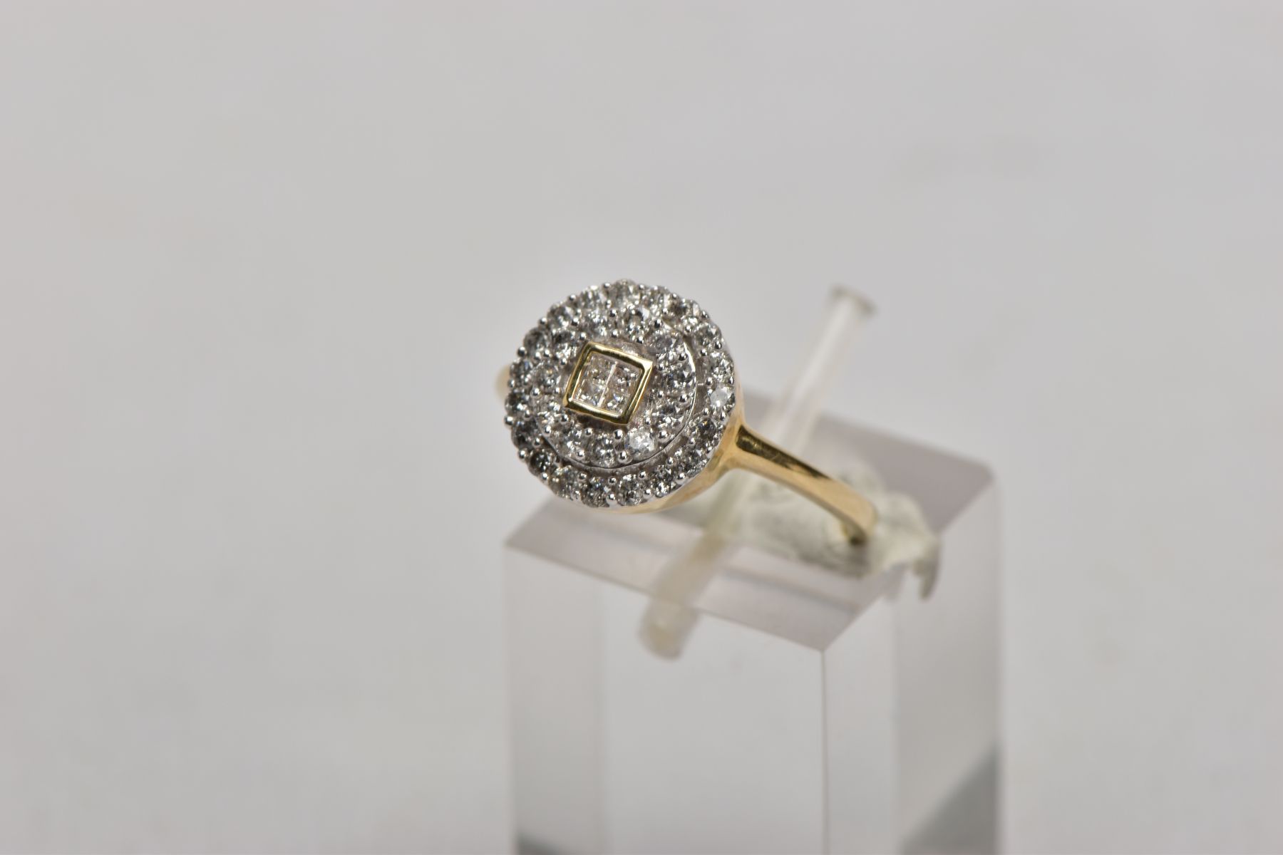 A 9CT GOLD DIAMOND CLUSTER RING, of a circular design, the central part set with four princess cut