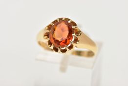 AN EARLY 20TH CENUTRY 18CT GOLD CITRINE RING, the oval citrine in a scalloped claw setting, 18ct