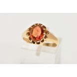 AN EARLY 20TH CENUTRY 18CT GOLD CITRINE RING, the oval citrine in a scalloped claw setting, 18ct