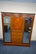 AN EDWARDIAN MAHOGANY AND INLAID COMPACTUM WARDROBE, the mirrored doors flanking a central door