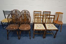 A SET OF FOUR STAINED BEECH WHEELBACK CHAIRS, along with a set of four oak chairs, and two other