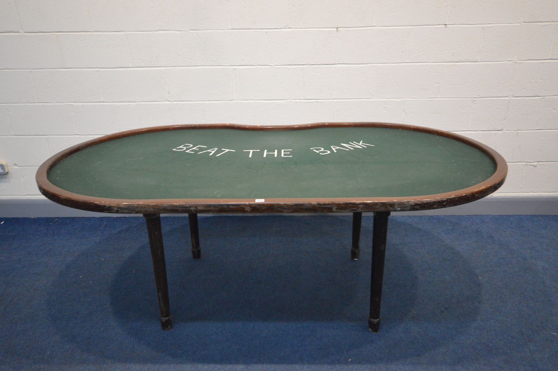 A BESPOKE MAHOGANY OVAL/KIDNEY SHAPED BLACK JACK GAMES TABLE, with green baize, on cylindrical legs,