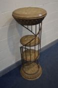 A CYLINDRICAL RESIN DISPLAY STAND, with a wrought iron gallery spiralling around three tier shelves,