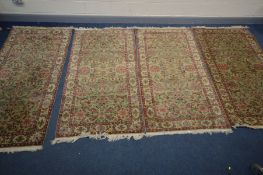 A SET OF FOUR WOOLLEN ISFAHAN RUGS, with a green field, and multi strap border, 208cm x 102cm