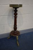 A MAHOGANY TORCHERE STAND, with a brass pierced gallery above a circular top, on turned and fluted