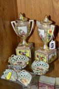 A PAIR OF LATE 19TH CENTURY VIENNA STYLE TWIN HANDLED URNS AND COVERS ON SEPARATE PLINTHS,