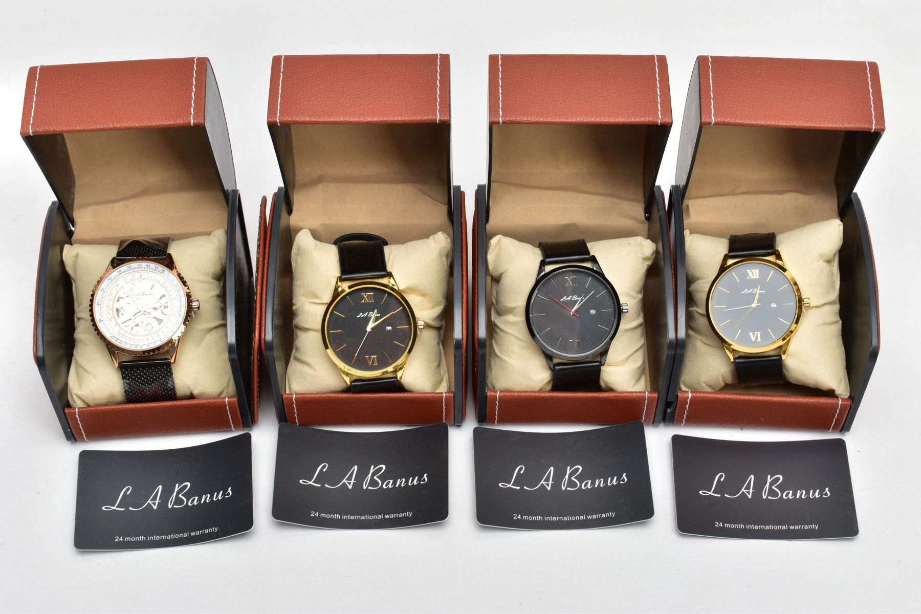 FOUR BOXED 'L. A. BANUS' WRISTWATCHES, two matching with round black dials Roman twelve and six