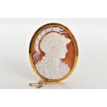 A YELLOW METAL CAMEO BROOCH, the brooch of an oval form, set with a carved shell cameo depicting the