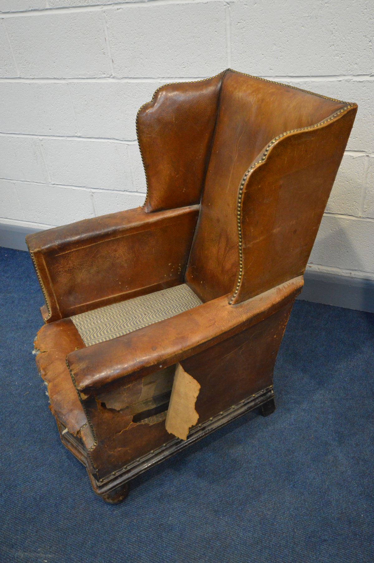 A PAIR OF DISTRESSED EARLY 20TH CENTURY BROWN LEATHER WINGBACK CLUB CHAIRS, on front bun feet, width - Image 6 of 7