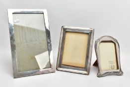 THREE SILVER PICTURE FRAMES, to include a large rectangular plain polished frame, hallmarked