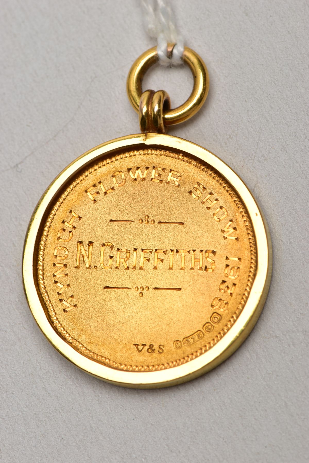 A 9CT GOLD FOB MEDAL, of a circular form, decorated with an embossed flower to the front, engraved - Image 3 of 5