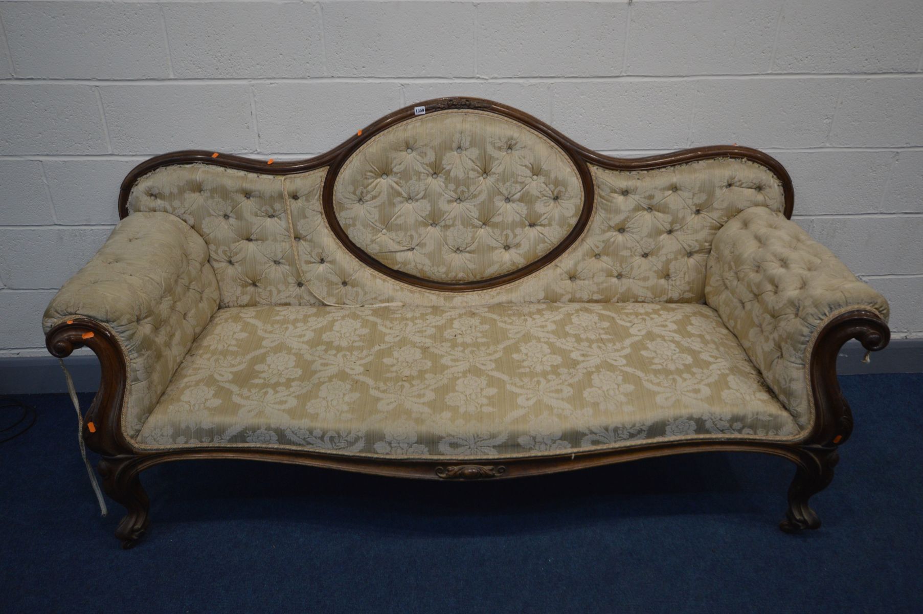 A VICTORIAN MAHOGANY SOFA, the wavy back to scrolled armrests, serpentine front, on cabriole legs,