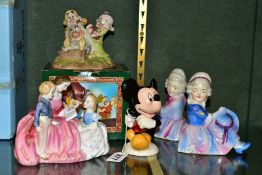 THREE ROYAL DOULTON FIGURES AND A PAIR OF CONTINENTAL POTTERY BOOKENDS, the Royal Doulton comprising