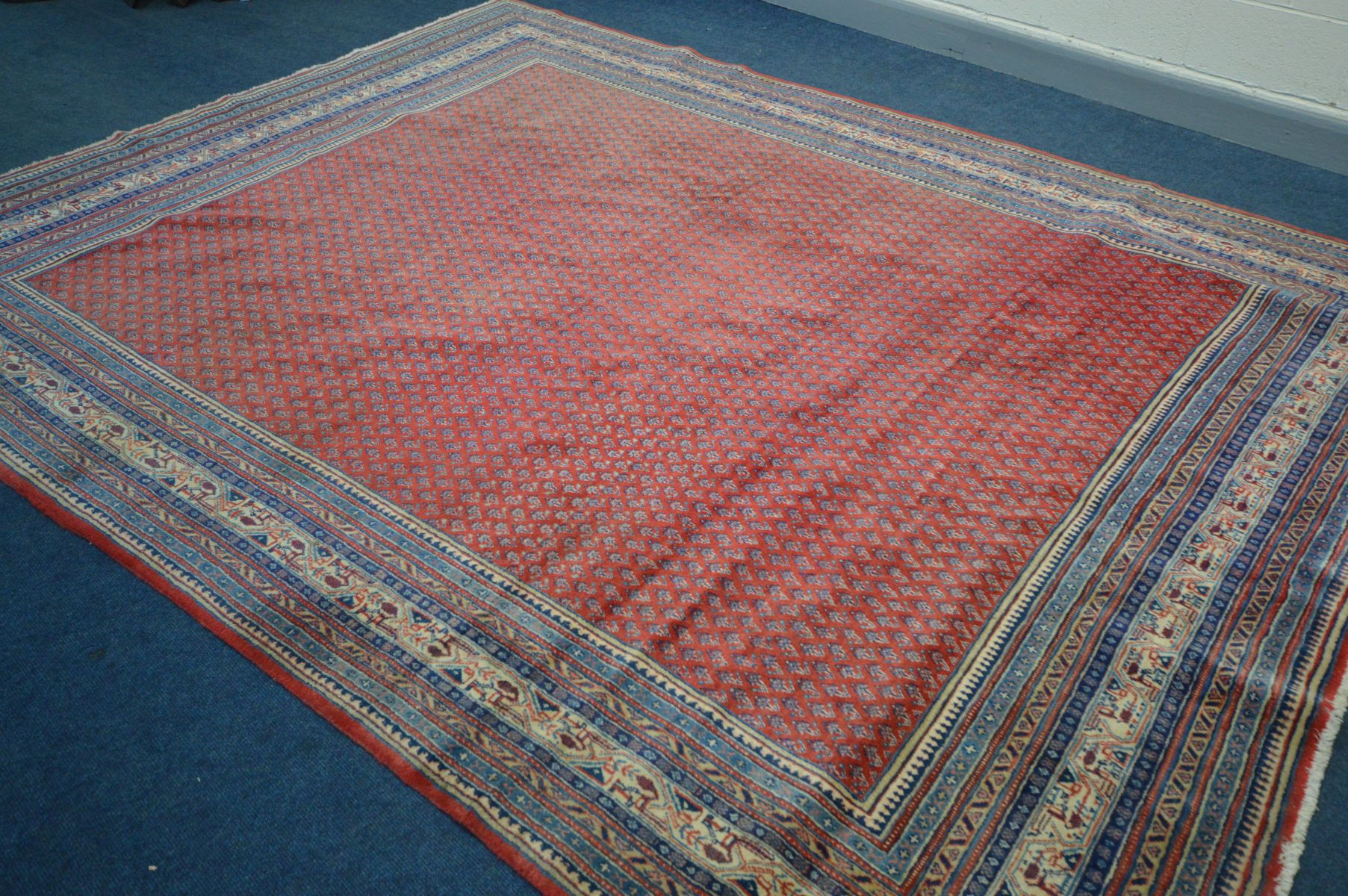 A RED GROUND WOOLEN RUG with a multistrap border, 360cm x 262cm (condition - overall good - Image 3 of 3
