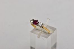 AN 18CT GOLD, RUBY AND DIAMOND THREE STONE RING, designed with a central circular cut ruby,