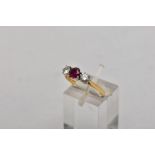 AN 18CT GOLD, RUBY AND DIAMOND THREE STONE RING, designed with a central circular cut ruby,