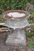 A LARGE COMPOSITE FONT STYLE PLANTER on a square plinth with an octagonal shaped top with quatrefoil