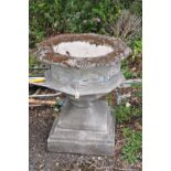 A LARGE COMPOSITE FONT STYLE PLANTER on a square plinth with an octagonal shaped top with quatrefoil
