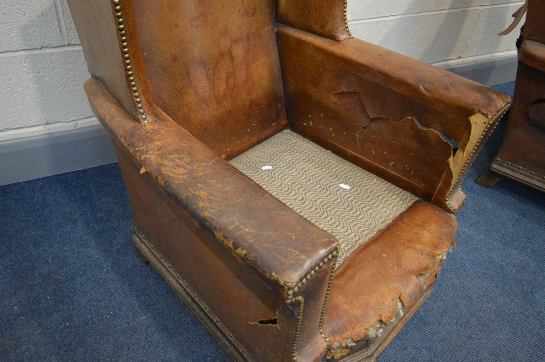 A PAIR OF DISTRESSED EARLY 20TH CENTURY BROWN LEATHER WINGBACK CLUB CHAIRS, on front bun feet, width - Image 5 of 7