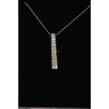 A 9CT WHITE GOLD DIAMOND PENDANT NECKLACE, the pendant of a slightly tapered rectangular form, set