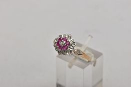 A 9CT GOLD RUBY AND DIAMOND CLUSTER RING, the three tier cluster set with a central single cut
