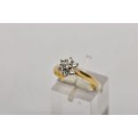 AN 18CT GOLD DIAMOND CLUSTER RING, slightly raised flower shape cluster with seven claw set round