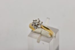 AN 18CT GOLD DIAMOND CLUSTER RING, slightly raised flower shape cluster with seven claw set round