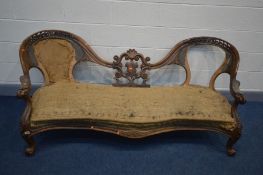 A VICTORIAN WALNUT OPEN DOUBLE BACK SOFA, the frame carved with foliate scrolls, shield centre