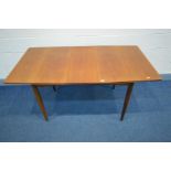 A MID 20TH CENTURY TEAK EXTENDING DINING TABLE, with a single additional leaf, on tapered