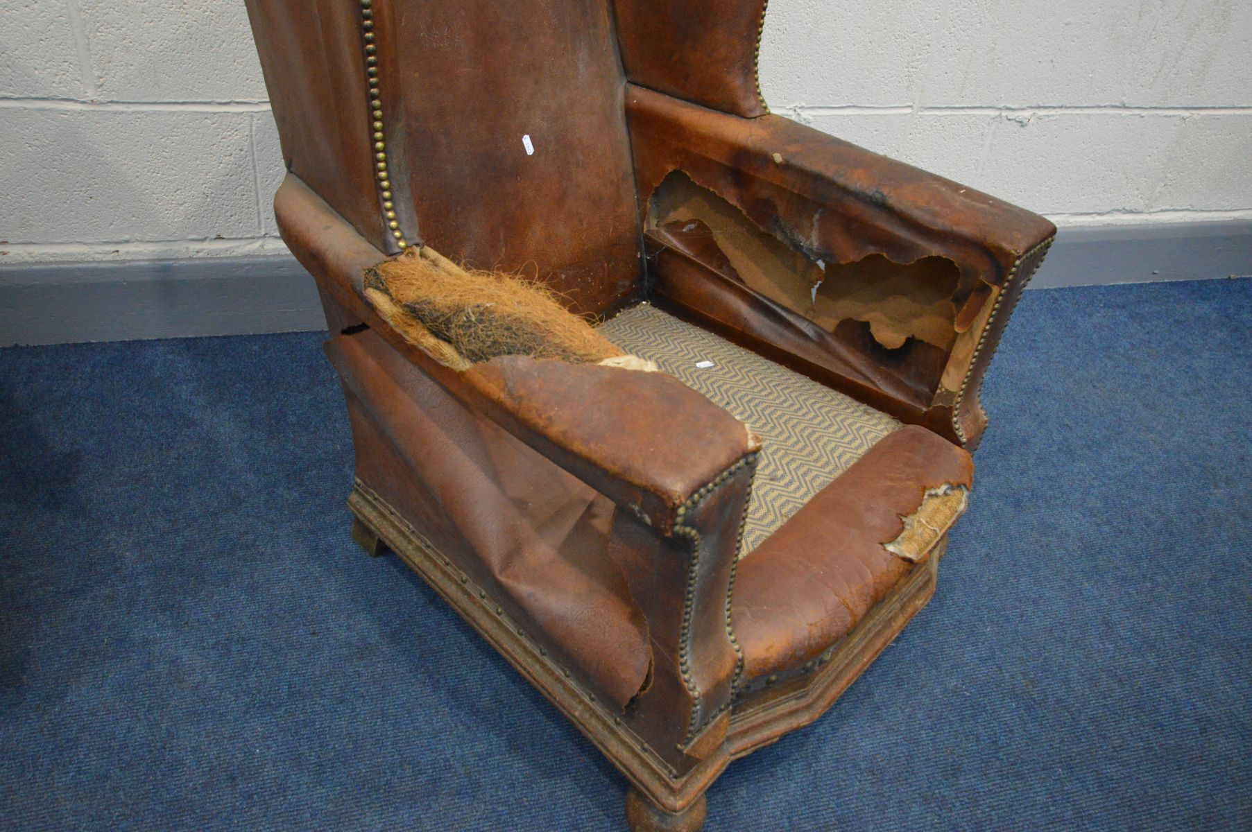 A PAIR OF DISTRESSED EARLY 20TH CENTURY BROWN LEATHER WINGBACK CLUB CHAIRS, on front bun feet, width - Image 4 of 7