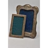 TWO EARLY 20TH CENTURY SILVER PHOTOGRAPH FRAMES, the first of Art Nouveau style design, hallmark