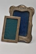 TWO EARLY 20TH CENTURY SILVER PHOTOGRAPH FRAMES, the first of Art Nouveau style design, hallmark