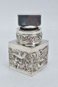 A LATE VICTORIAN WILLIAM COMYNS SILVER MOUNTED SQUARE GLASS TOILET JAR AND STOPPER, repousse