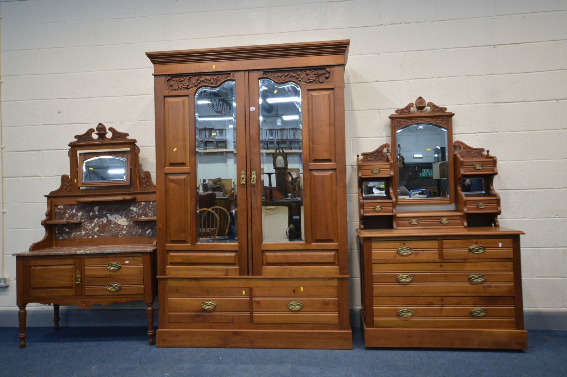 AN EDWARDIAN SATINWOOD THREE PIECE BEDROOM SUITE, comprising a mirrored double door wardrobe, in two