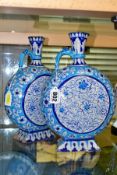 A PAIR OF LATE 19TH/EARLY 20TH CENTURY IZNIK STYLE EWERS, of moon flask form, the turquoise and blue