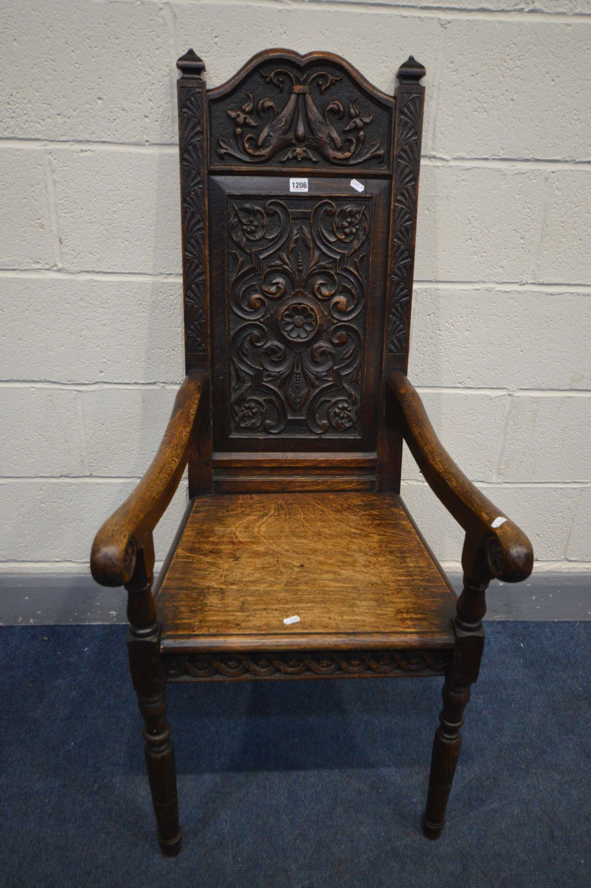 A 19TH CENTURY CARVED OAK WAINSCOT CHAIR, foliate carved back, solid seat and open armrests, width - Image 2 of 2