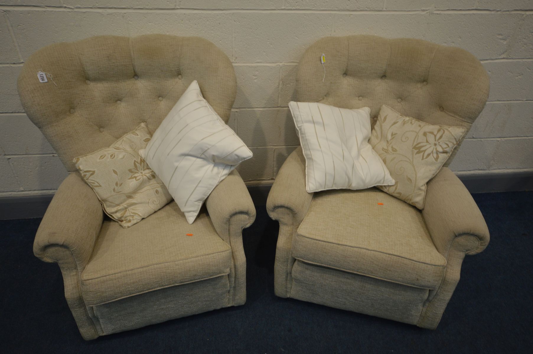 A NEAR PAIR PLUMBS CREAM UPHOLSTERED BUTTON BACK ARMCHAIRS, one chair with a sprung back to base,
