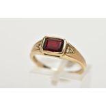 A 9CT GOLD GARNET AND DIAMOND DRESS RING, centring on a rectangular cut garnet, flanked with round