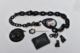 A BAG OF VICTORIAN CARVED JET ITEMS, to include two miniature cat figurines, a carved cameo and