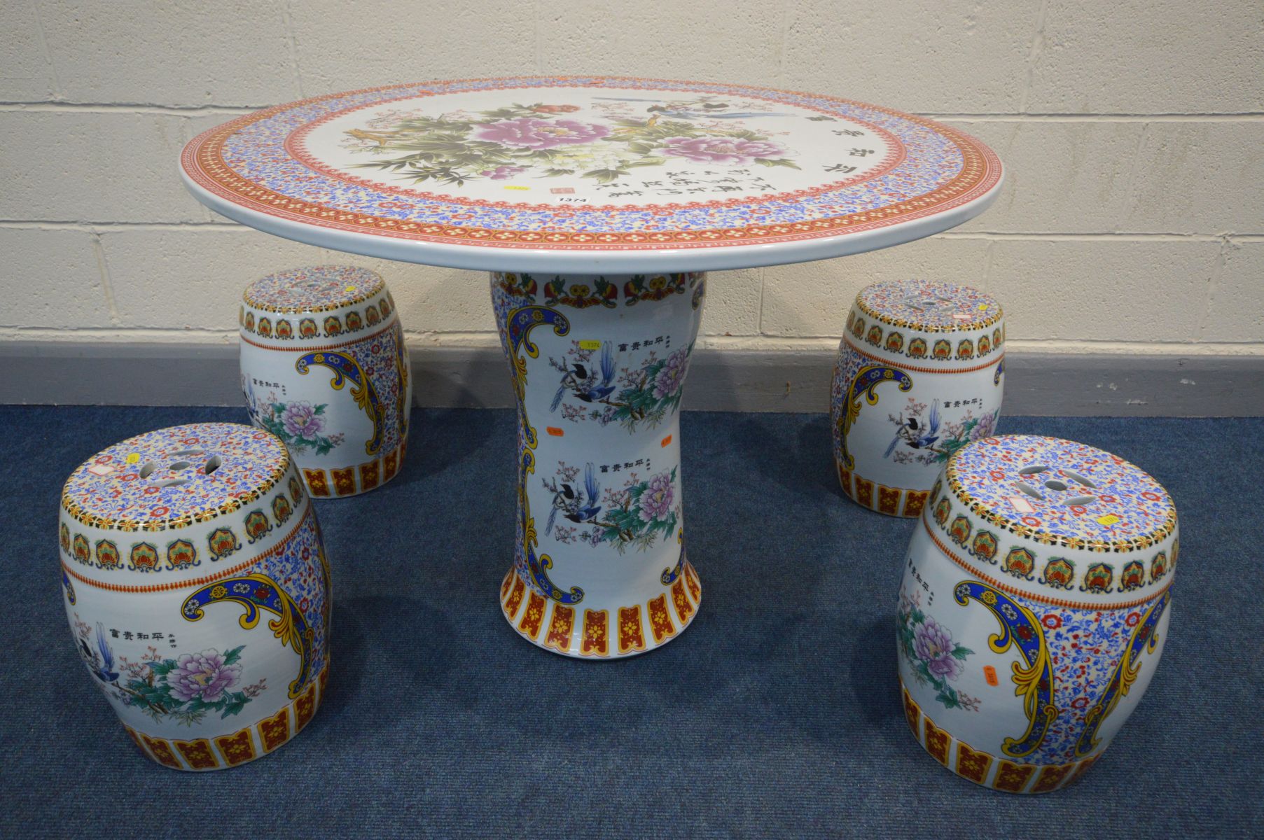 AN ORIENTAL PORCELAIN CIRCULAR TABLE, on a pedestal base, with chinoiserie decoration and majority
