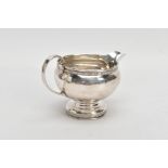 A MID 20TH CENTURY SILVER CREAM JUG, plain polished baluster form, scroll detailed handle, with a
