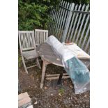 A MODERN HARDWOOD GARDEN TABLE 125cm in diameter (stretcher base dislocated), two folding chairs (