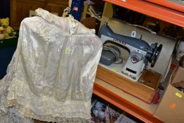 A CIRCA 1960'S WEDDING DRESS, CHRISTENING ROBE, VINTAGE SEWING MACHINE AND TWO BOXES OF ASSORTED