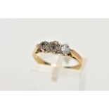 A YELLOW METAL THREE STONE DIAMOND RING, designed with three graduated round brilliant cut diamonds,