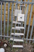 A PAIR OF ALUMINIUM STEP LADDERS 166cm and 164cm high respectively