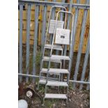 A PAIR OF ALUMINIUM STEP LADDERS 166cm and 164cm high respectively