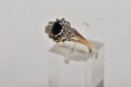 A 9CT GOLD SAPPHIRE AND DIAMOND CLUSTER RING, designed as a central oval sapphire within a single