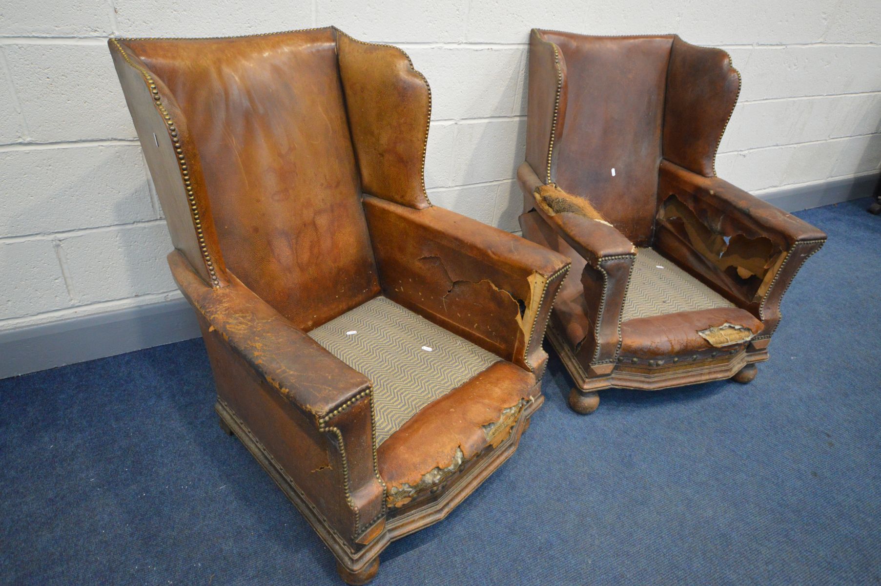A PAIR OF DISTRESSED EARLY 20TH CENTURY BROWN LEATHER WINGBACK CLUB CHAIRS, on front bun feet, width - Image 2 of 7