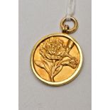 A 9CT GOLD FOB MEDAL, of a circular form, decorated with an embossed flower to the front, engraved