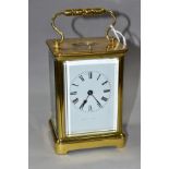 AN EARLY 20TH CENTURY FRENCH BRASS CARRIAGE CLOCK, the rectangular case with small oval panel to the